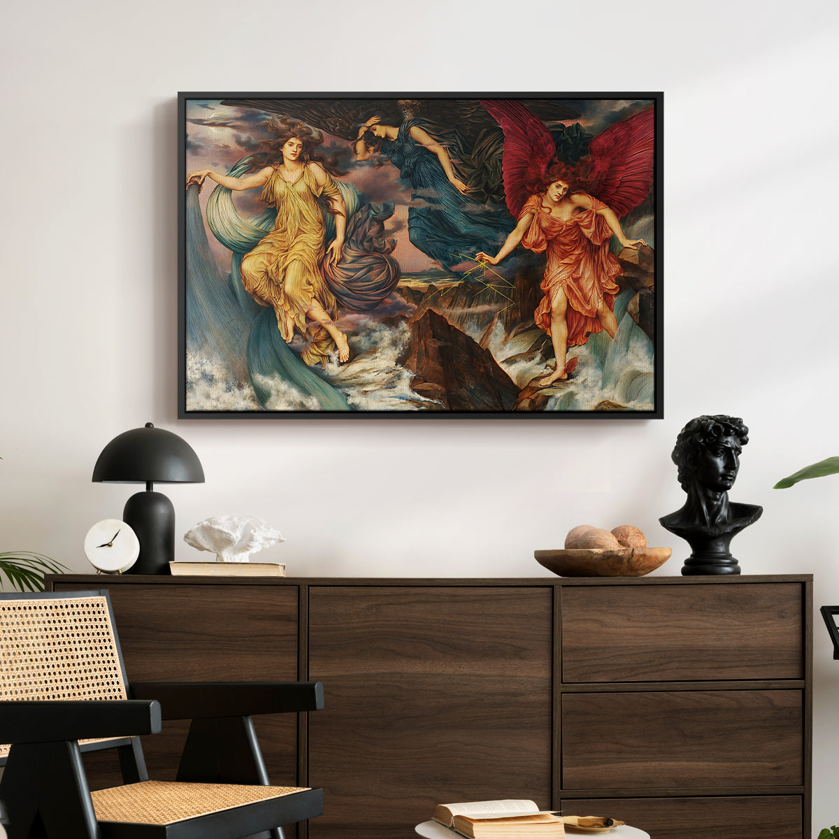 The Storm Spirits, 1900 by Evelyn De Morgan displayed in a black floater framed canvas above a dark wood credenza in an entryway.