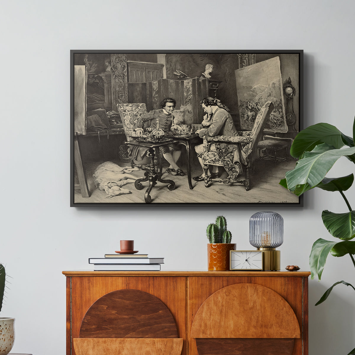 The Chess Players, 1858 by Ernest Meissonier in a black floater framed canvas featuring two men seated at table playing chess in detailed interior setting, displayed above a wood console cabinet.