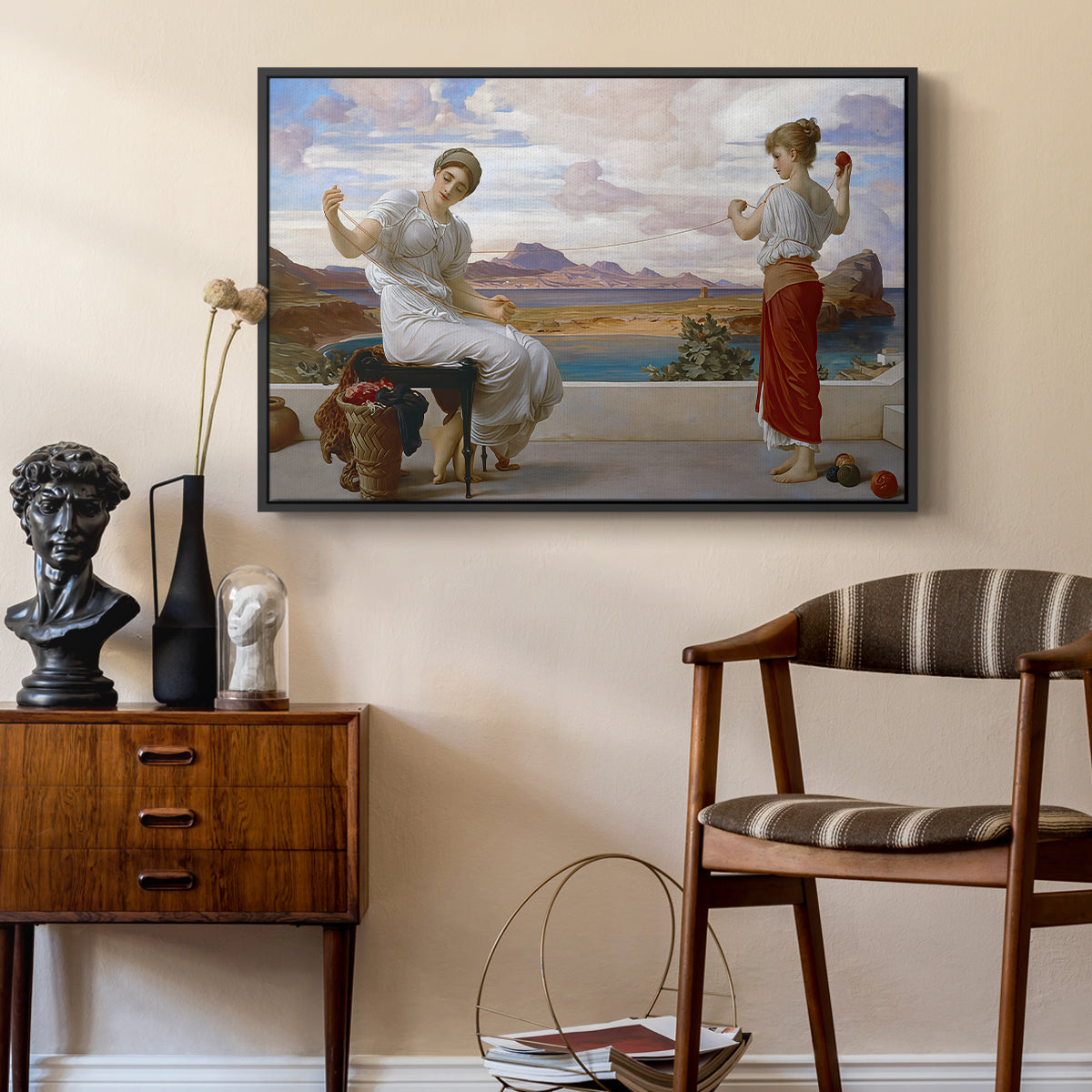 Winding the Skein, c. 1878 by Frederic Leighton as a black floater framed canvas featuring a classical scene of figures winding thread together, styled above a mid-century console in a contemporary living area.
