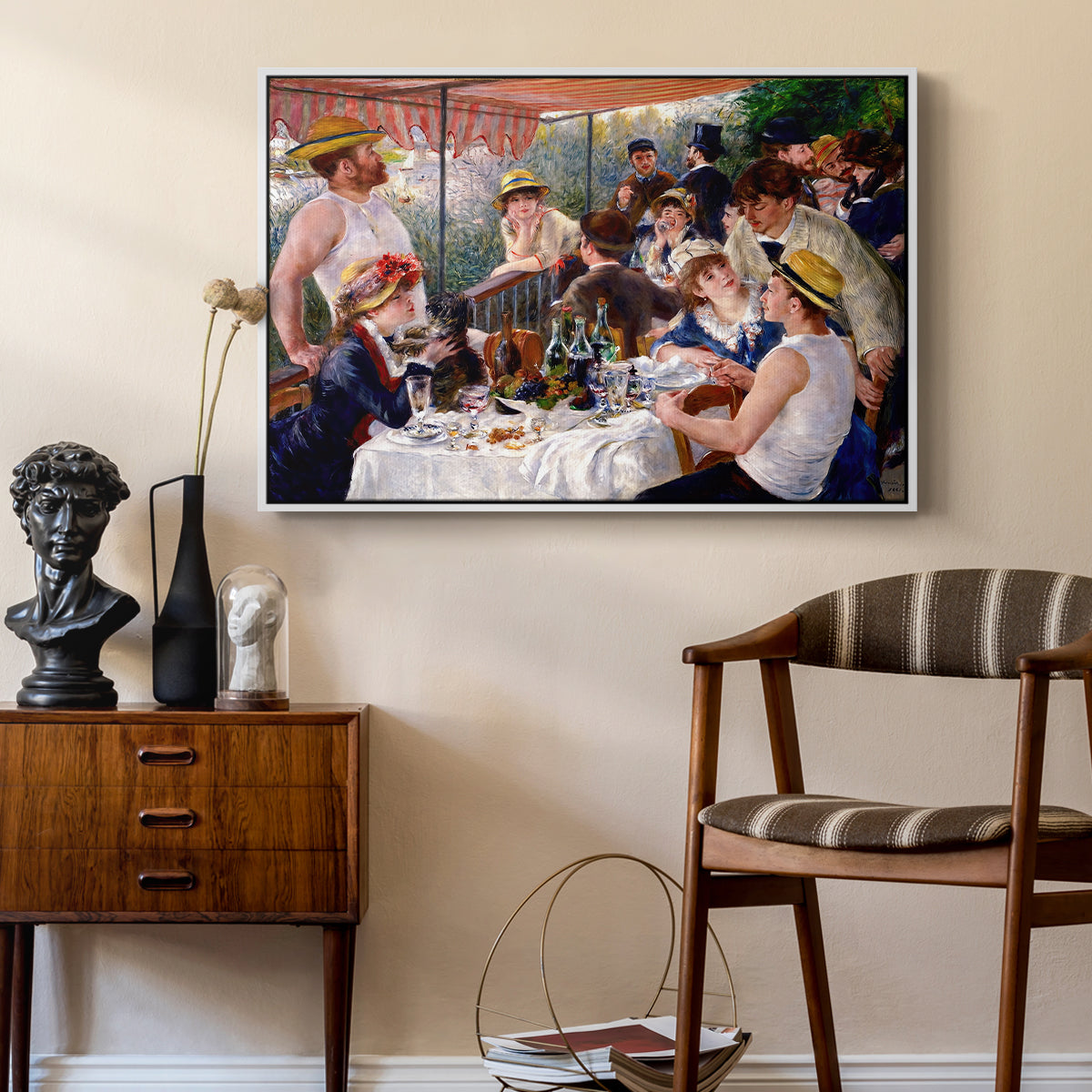 Luncheon of the Boating Party (Le Déjeuner des canotiers), 1880-1881 by Pierre-Auguste Renoir as a white floater framed canvas featuring an impressionist scene of friends enjoying lunch with wine and conversation, styled above a mid-century console in a contemporary living area.