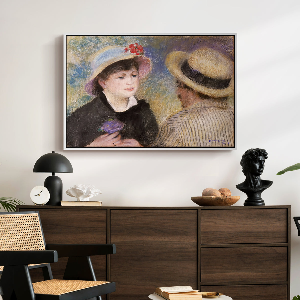 Boating Couple (Aline Charigot and Renoir), c. 1881 by Pierre-Auguste Renoir displayed in a white floater framed canvas above a dark wood credenza in an entryway.
