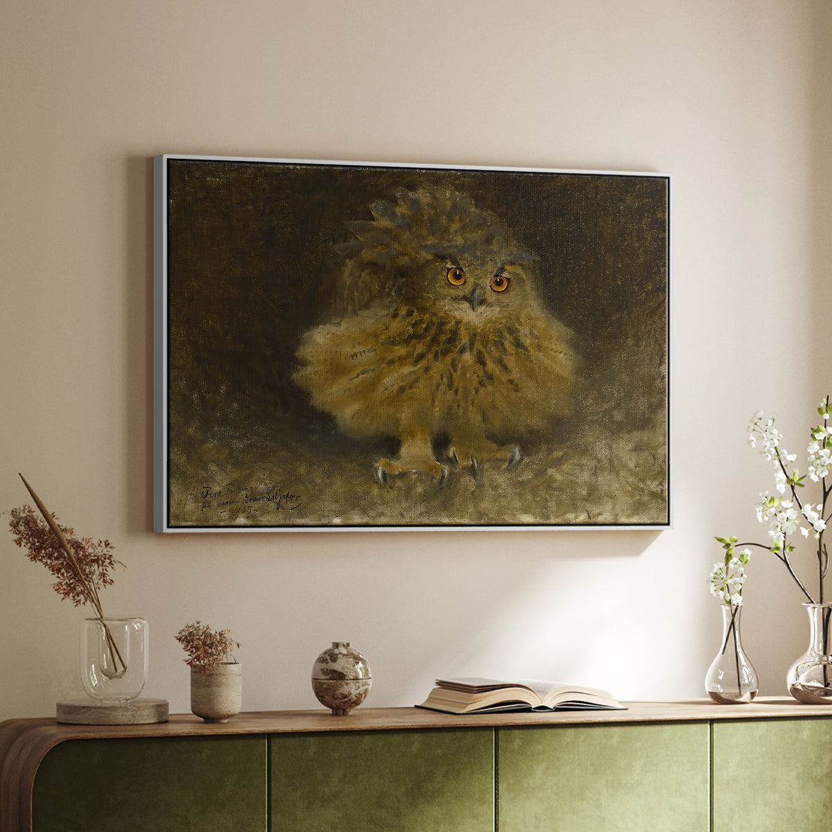 White floater framed canvas of An Eagle Owl (Berguv), 1905 by Bruno Liljefors, featuring a detailed wildlife painting of eagle owl with piercing eyes in darkness above a sideboard in a softly lit hallway.