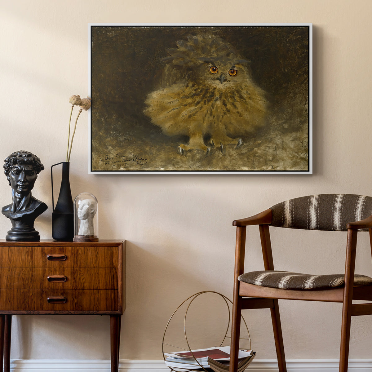 An Eagle Owl (Berguv), 1905 by Bruno Liljefors as a white floater framed canvas featuring a bird of prey resting on tree branch with textured feathers, styled above a mid-century console in a contemporary living area.