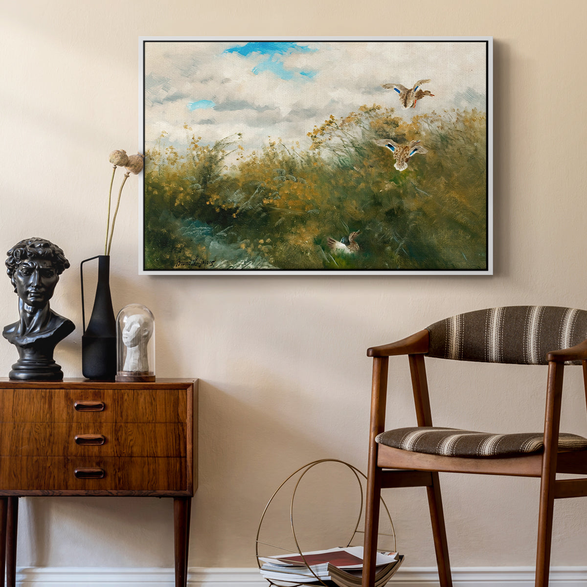 Wild Ducks (Grasänder), 1890 by Bruno Liljefors as a white floater framed canvas featuring a group of ducks foraging in natural marsh setting, styled above a mid-century console in a contemporary living area.