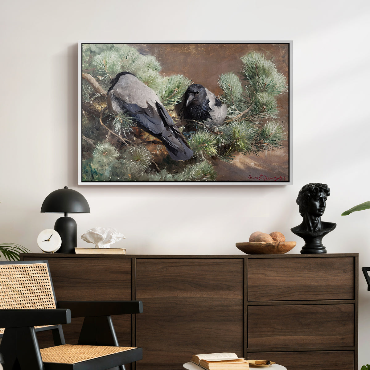 Hooded Crows (Kråkor), 1891 by Bruno Liljefors displayed in a white floater framed canvas above a dark wood credenza in an entryway.