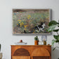 Cat on a Flowery Meadow, 1887 by Bruno Liljefors in a white floater framed canvas featuring a cat crouching in a meadow filled with wildflowers and greenery, displayed above a wood console cabinet.