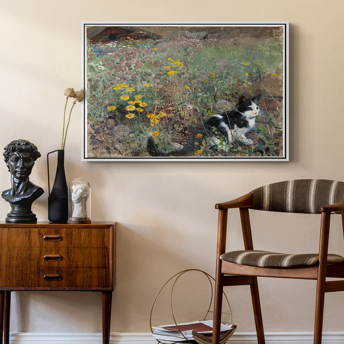Cat on a Flowery Meadow, 1887 by Bruno Liljefors as a white floater framed canvas featuring an animal scene of cat hidden in lush meadow vegetation, styled above a mid-century console in a contemporary living area.