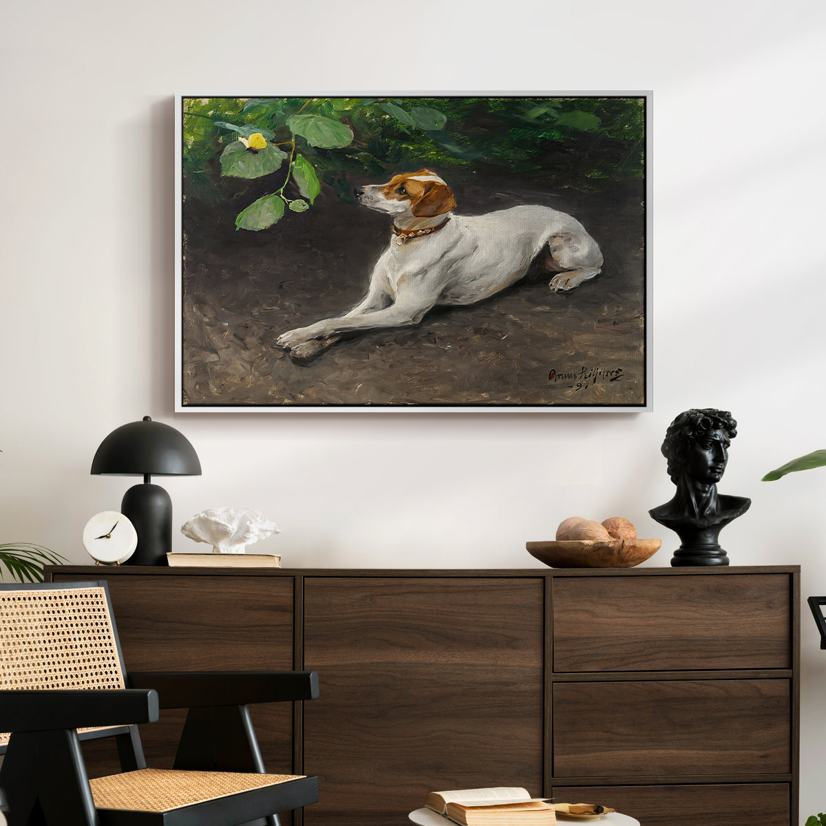 Portrait of a Dog, 1891 by Bruno Liljefors displayed in a white floater framed canvas above a dark wood credenza in an entryway.
