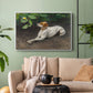 White floater framed canvas featuring a calm scene of dog reclining in open landscape, displayed above a sofa in a modern living room.