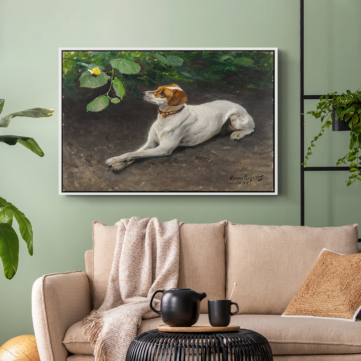 White floater framed canvas featuring a calm scene of dog reclining in open landscape, displayed above a sofa in a modern living room.