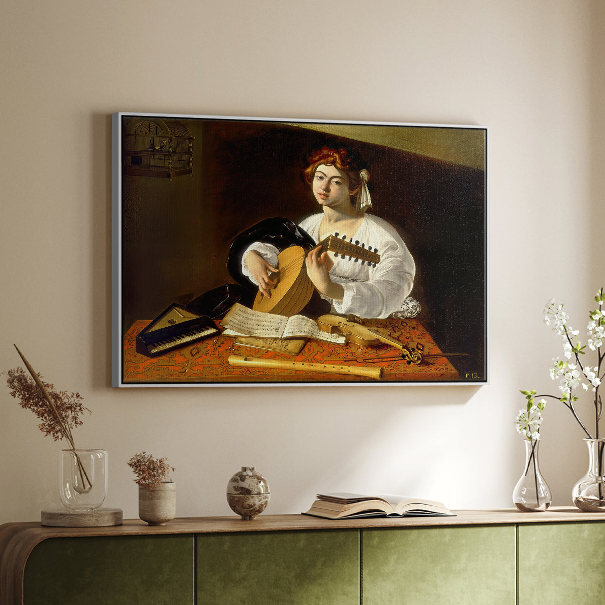 White floater framed canvas of The Lute Player (Wildenstein Version), c. 1596 by Caravaggio, featuring a musician seated with lute and musical instruments on table above a sideboard in a softly lit hallway.