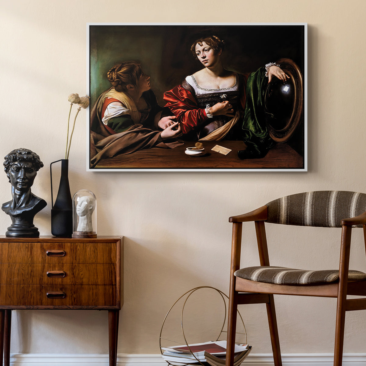 Martha and Mary Magdalene, c. 1598 by Caravaggio as a white floater framed canvas featuring an intimate interaction between two women with mirror and objects, styled above a mid-century console in a contemporary living area.