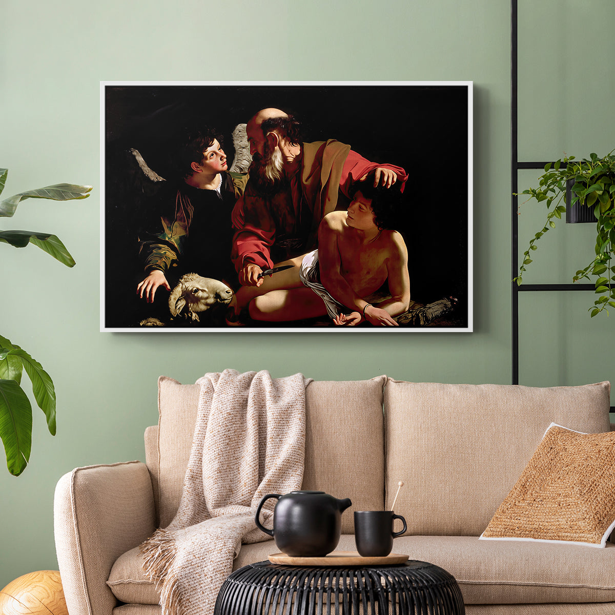 White floater framed canvas featuring an intense religious narrative with figures in close physical struggle, displayed above a sofa in a modern living room.