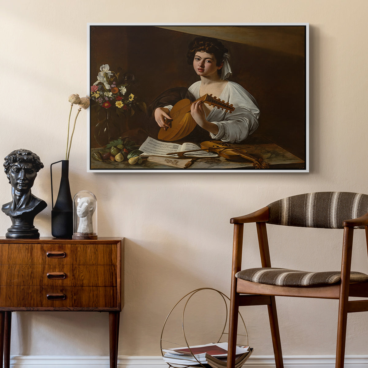 The Lute Player (Hermitage Version), c. 1596 by Caravaggio as a white floater framed canvas featuring an intimate musical scene with instrument and decorative objects, styled above a mid-century console in a contemporary living area.