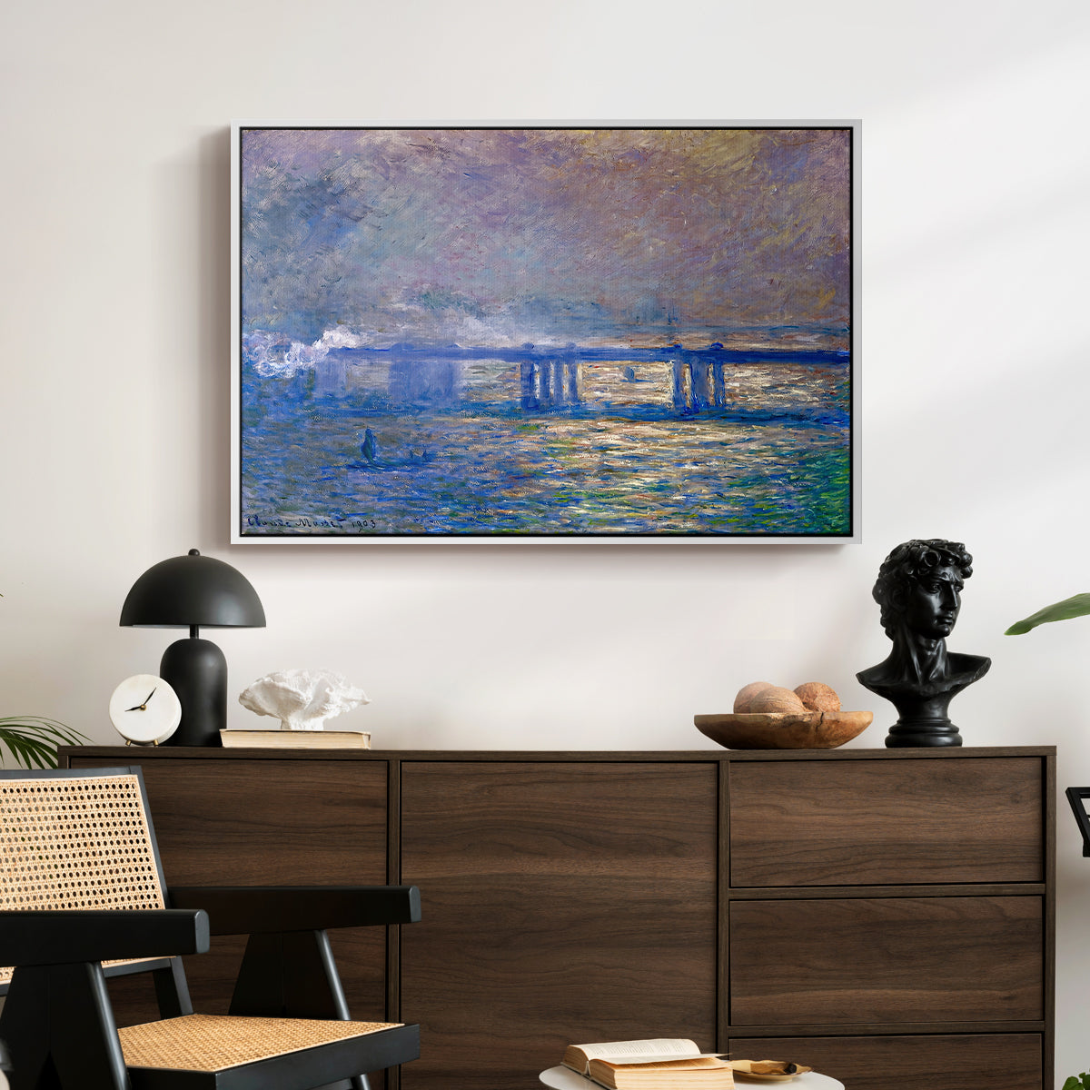Charing Cross Bridge, 1903 by Claude Monet displayed in a white floater framed canvas above a dark wood credenza in an entryway.