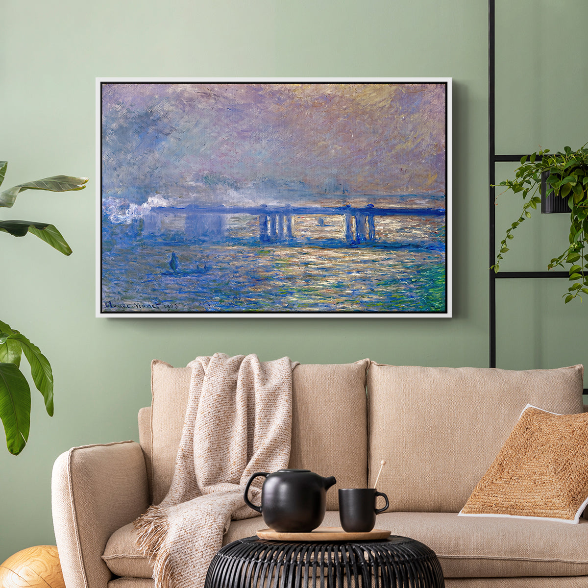 White floater framed canvas featuring a city bridge scene softened by mist and impressionist brushwork, displayed above a sofa in a modern living room.