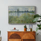 Banks of the Seine, Vétheuil, 1880 by Claude Monet in a white floater framed canvas featuring a riverbank landscape with water, trees, and distant village buildings, displayed above a wood console cabinet.
