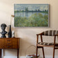 Banks of the Seine, Vétheuil, 1880 by Claude Monet as a white floater framed canvas featuring a tranquil riverside scene with houses and vegetation, styled above a mid-century console in a contemporary living area.