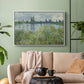 White floater framed canvas featuring a natural landscape with calm water and soft foliage, displayed above a sofa in a modern living room.