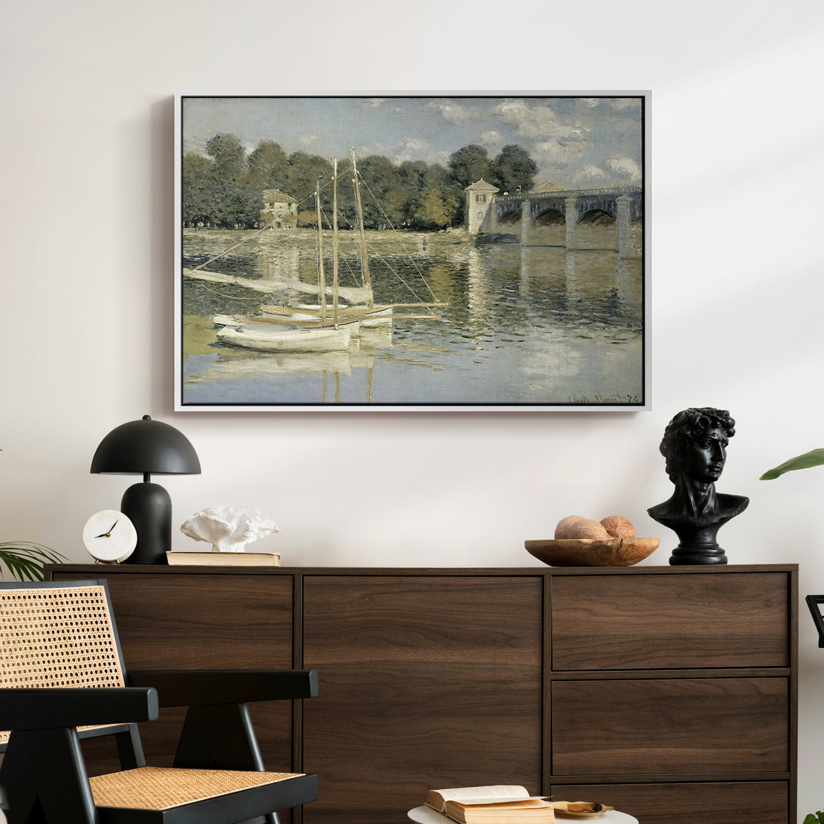 The Bridge at Argenteuil, 1874 by Claude Monet displayed in a white floater framed canvas above a dark wood credenza in an entryway.