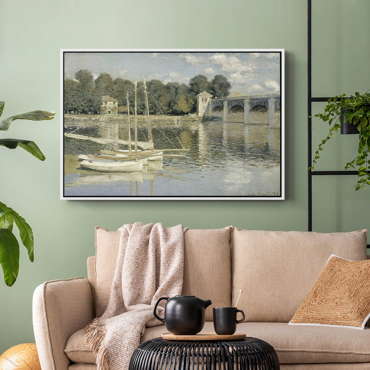 White floater framed canvas featuring a riverside view with architecture and nautical activity, displayed above a sofa in a modern living room.