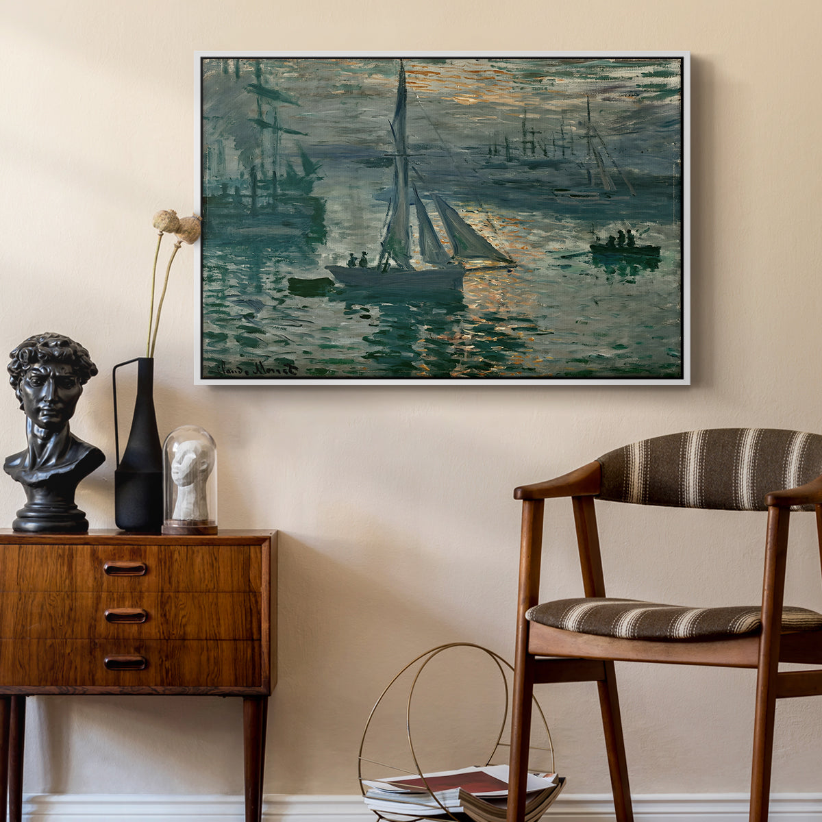 Sunrise (Marine), 1873 by Claude Monet as a white floater framed canvas featuring an early morning harbor scene with boats and diffused light, styled above a mid-century console in a contemporary living area.