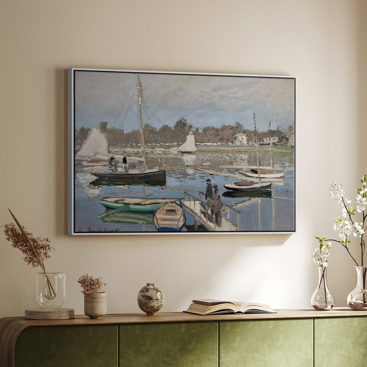 White floater framed canvas of The Basin at Argenteuil, 1874 by Claude Monet, featuring an impressionist boating scene with clustered masts and gentle ripples above a sideboard in a softly lit hallway.