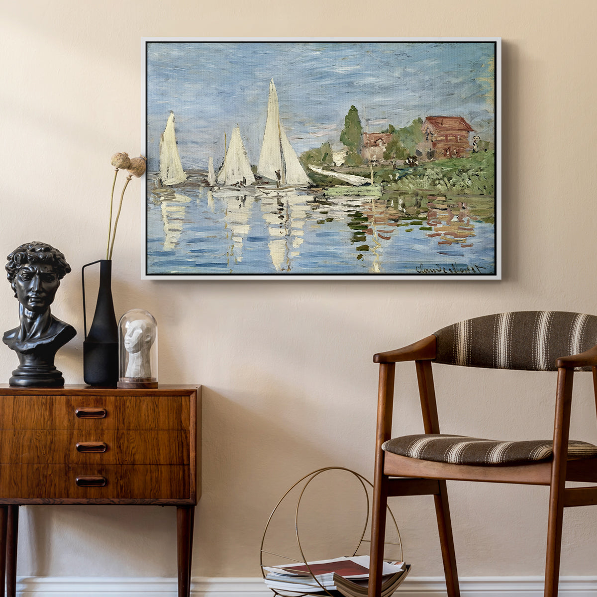 Regatta at Argenteuil, 1872 by Claude Monet as a white floater framed canvas featuring an impressionist depiction of sailing competition on water, styled above a mid-century console in a contemporary living area.