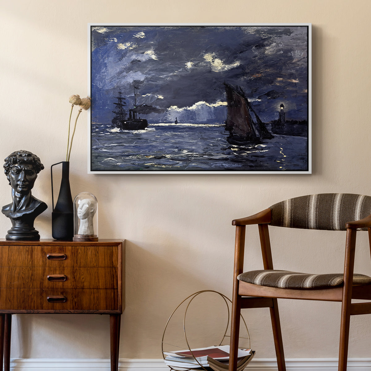 A Seascape, Shipping by Moonlight, 1864 by Claude Monet as a white floater framed canvas featuring a dramatic ocean scene with light reflecting across water at night, styled above a mid-century console in a contemporary living area.