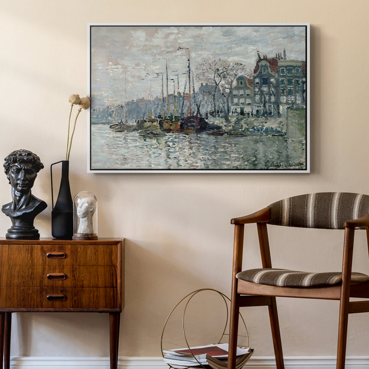 View of the Prins Hendrikkade and Kromme Waal in Amsterdam, 1874 by Claude Monet as a white floater framed canvas featuring an urban waterway with docked boats and European buildings, styled above a mid-century console in a contemporary living area.