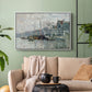 White floater framed canvas featuring a harbor view with masts, houses, and reflections in water, displayed above a sofa in a modern living room.