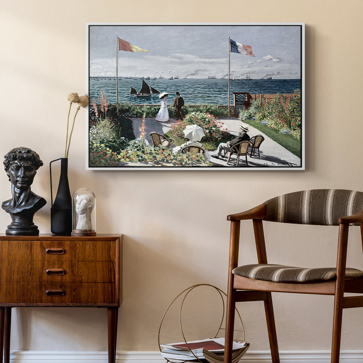 Garden at Sainte-Adresse, 1867 by Claude Monet as a white floater framed canvas featuring a vibrant garden scene with colorful blooms and distant sea, styled above a mid-century console in a contemporary living area.