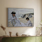 White floater framed canvas of On the Beach at Trouville, 1870 by Claude Monet, featuring an impressionist seaside scene with women in dresses and hats above a sideboard in a softly lit hallway.