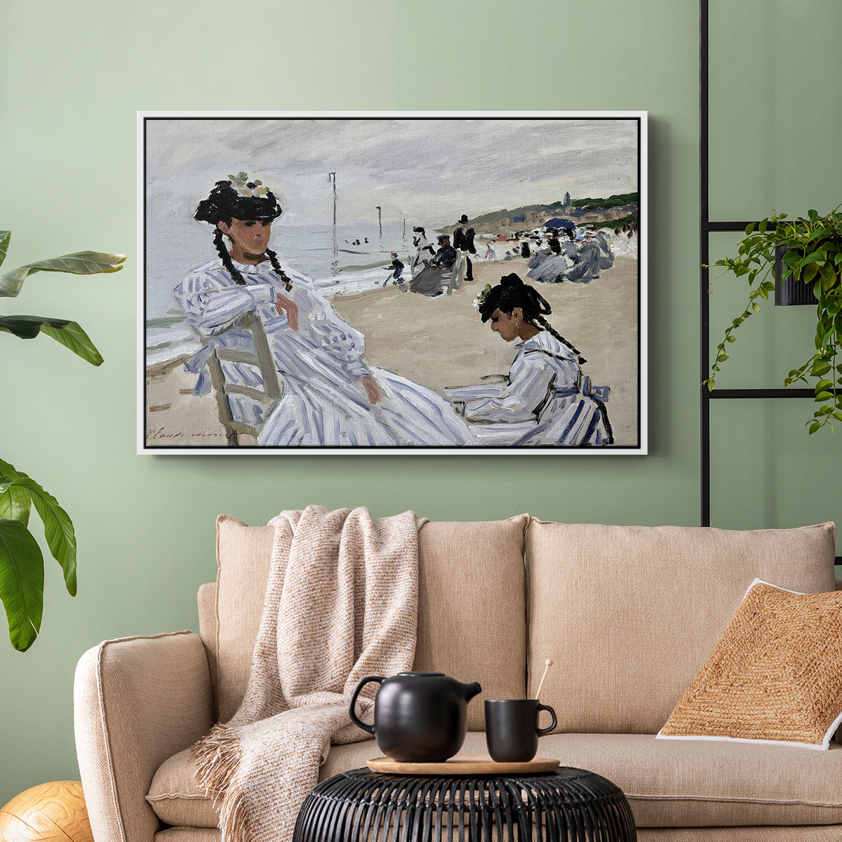 White floater framed canvas featuring a coastal leisure scene with figures looking out to sea, displayed above a sofa in a modern living room.