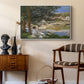 On the Bank of the Seine, Bennecourt, 1868 by Claude Monet as a white floater framed canvas featuring an impressionist landscape with people relaxing along the Seine, styled above a mid-century console in a contemporary living area.