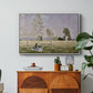 Summer (L'ete), 1874 by Claude Monet in a white floater framed canvas featuring a woman seated in grassy field beneath tree in bright summer landscape, displayed above a wood console cabinet.