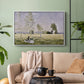 White floater framed canvas featuring a tranquil summer landscape with lone figure in nature, displayed above a sofa in a modern living room.