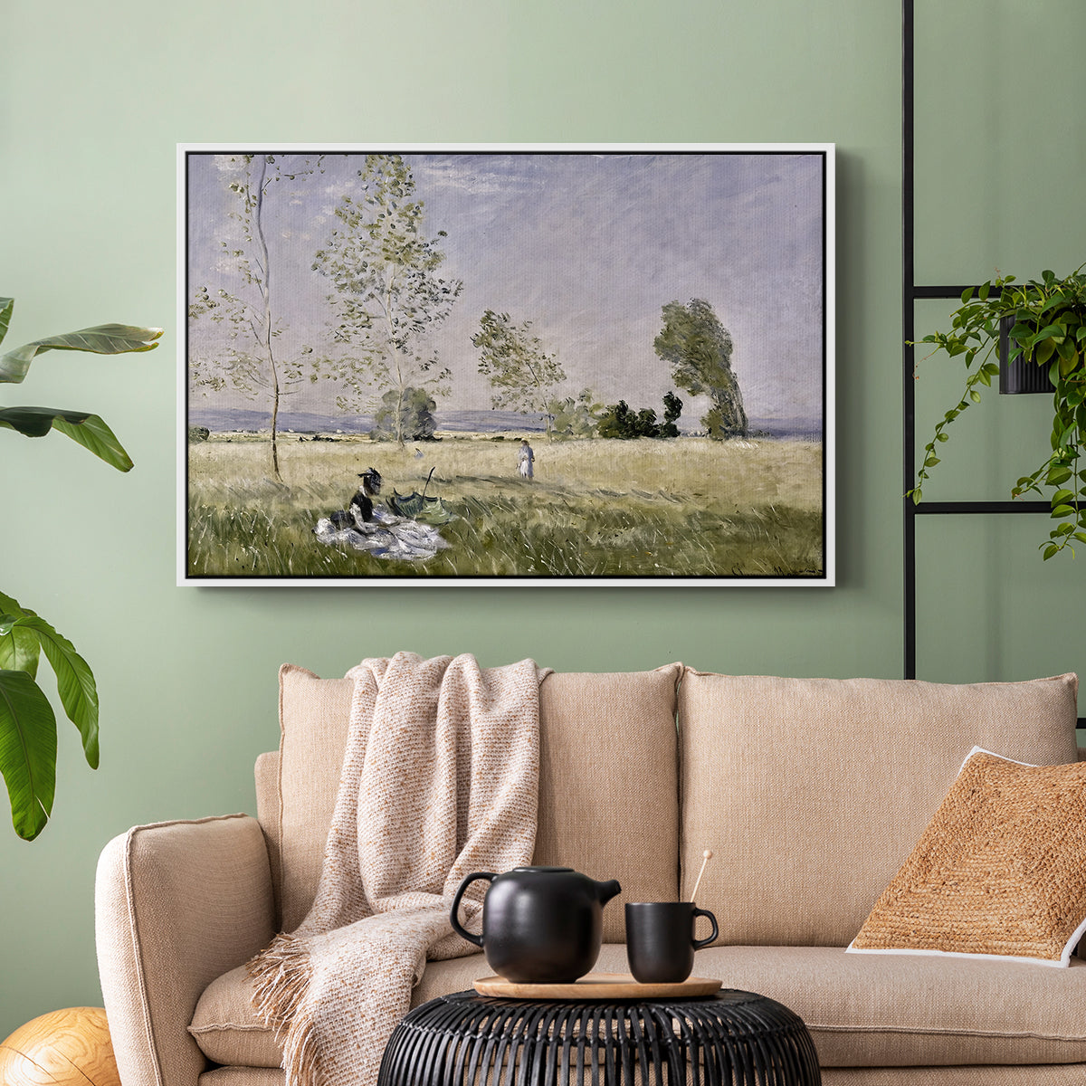 White floater framed canvas featuring a tranquil summer landscape with lone figure in nature, displayed above a sofa in a modern living room.