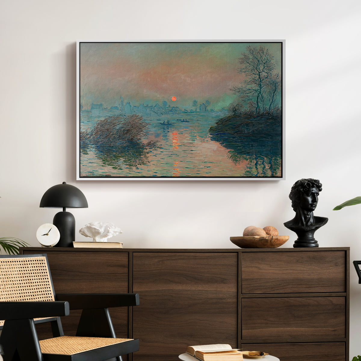 Sunset on the Seine at Lavacourt, Winter Effect, 1880 by Claude Monet displayed in a white floater framed canvas above a dark wood credenza in an entryway.