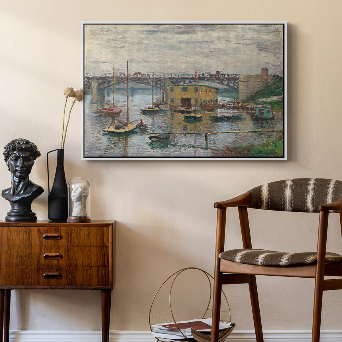 Bridge at Argenteuil on a Gray Day, c. 1876 by Claude Monet as a white floater framed canvas featuring a calm water scene with bridge fading into cloudy sky, styled above a mid-century console in a contemporary living area.