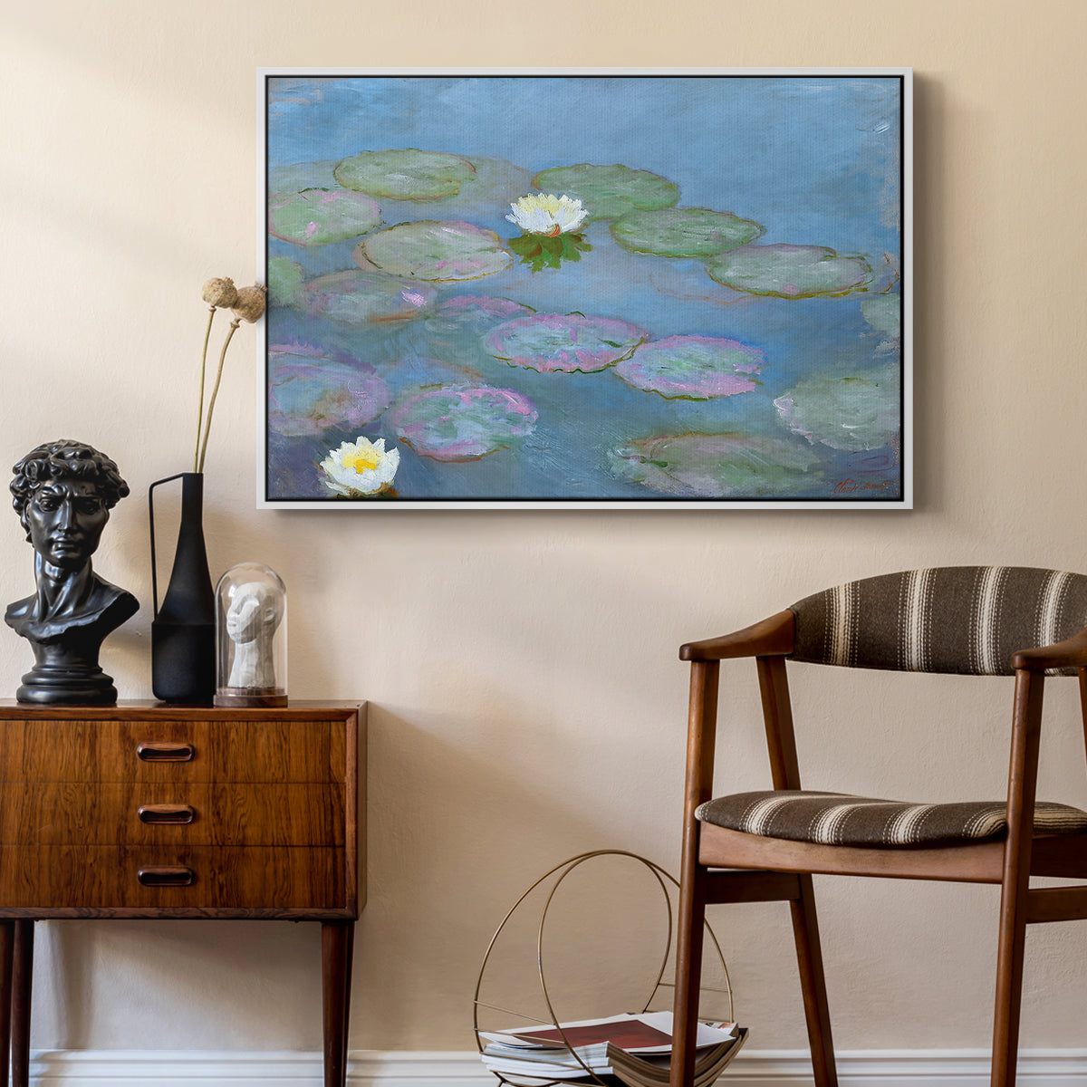 Water Lilies (Nymphéas), 1897-1899 by Claude Monet as a white floater framed canvas featuring a tranquil water surface covered with blooming lilies, styled above a mid-century console in a contemporary living area.