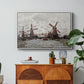 Windmills near Zaandam, 1871 by Claude Monet in a white floater framed canvas featuring windmills standing beside water under open sky in rural landscape, displayed above a wood console cabinet.
