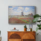 Tulip Fields with the Rijnsburg Windmill, 1886 by Claude Monet in a white floater framed canvas featuring colorful rows of tulip fields leading toward distant windmill, displayed above a wood console cabinet.