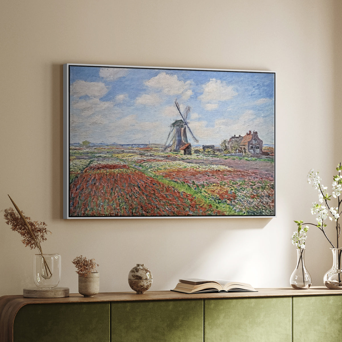 White floater framed canvas of Tulip Fields with the Rijnsburg Windmill, 1886 by Claude Monet, featuring a vibrant agricultural landscape with flowers and windmill above a sideboard in a softly lit hallway.