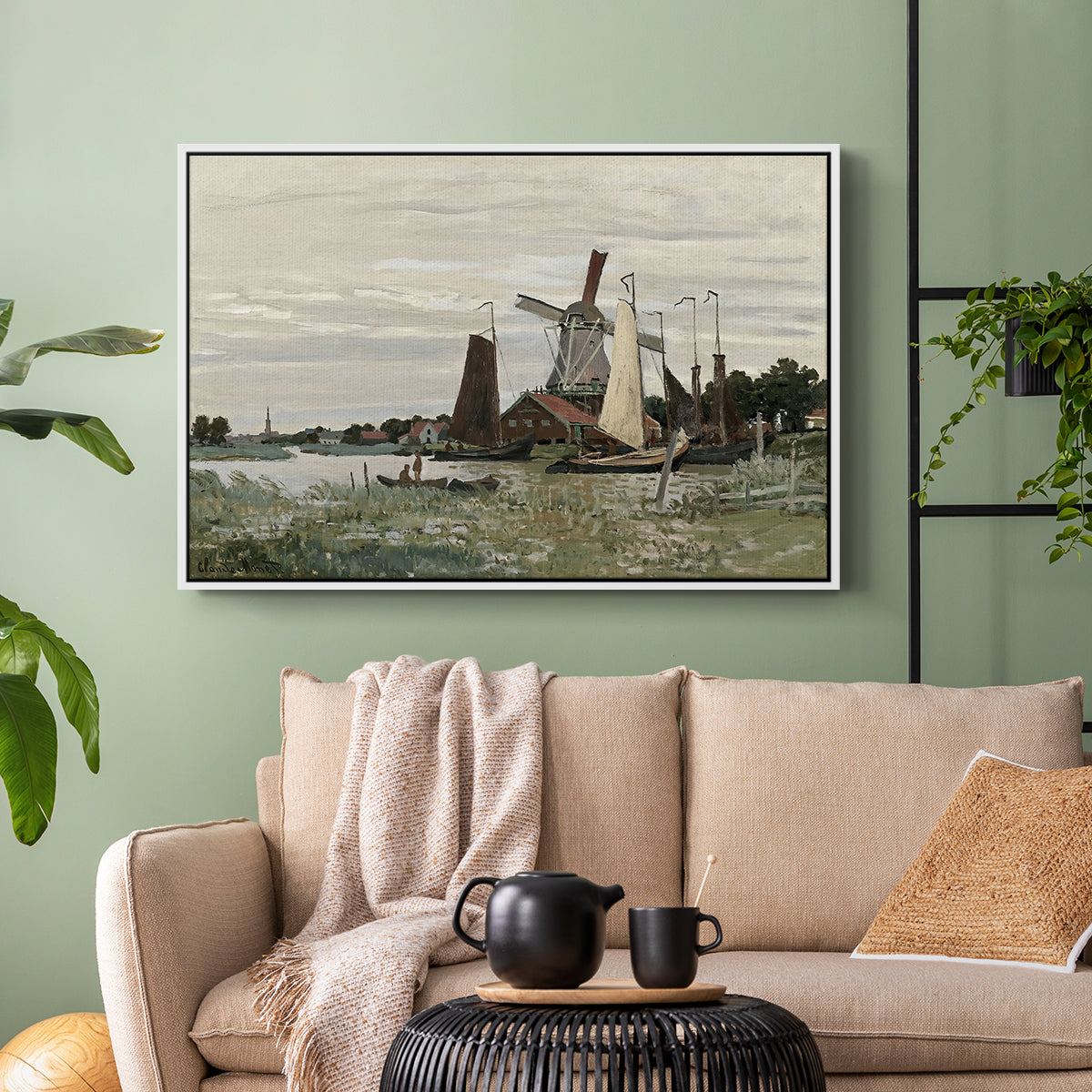 White floater framed canvas featuring a countryside structure standing against open sky, displayed above a sofa in a modern living room.