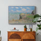 The Cliff Walk at Pourville, 1882 by Claude Monet in a white floater framed canvas featuring figures walking along coastal cliff path overlooking ocean and sky, displayed above a wood console cabinet.
