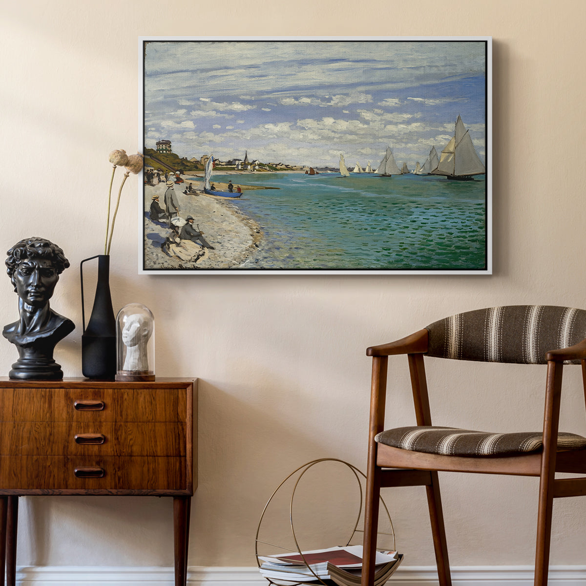 Regatta at Sainte-Adresse, 1867 by Claude Monet as a white floater framed canvas featuring an impressionist coastal view with colorful sails and shoreline activity, styled above a mid-century console in a contemporary living area.