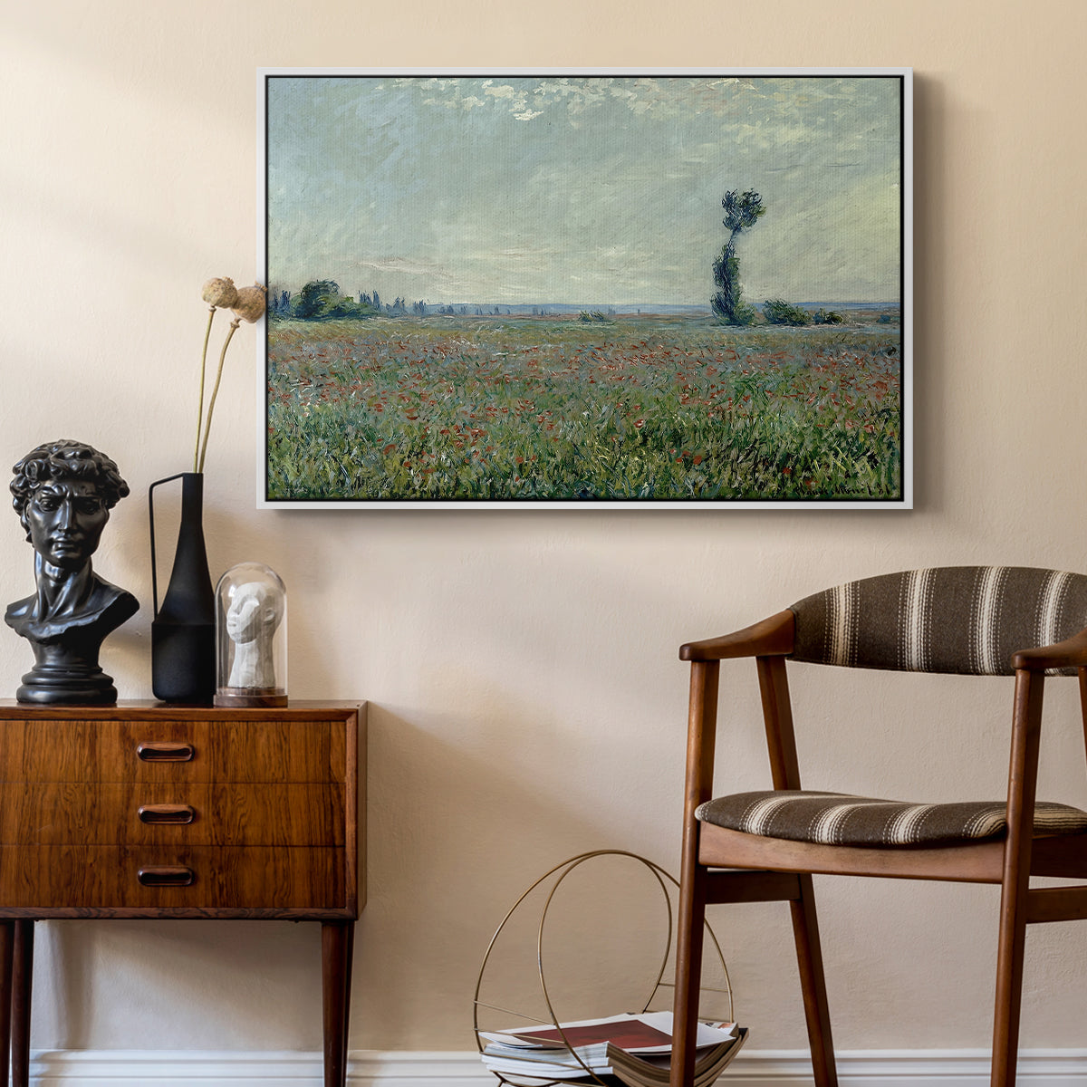 Poppy Field, 1881 by Claude Monet as a white floater framed canvas featuring a rural meadow with scattered poppies and soft horizon, styled above a mid-century console in a contemporary living area.