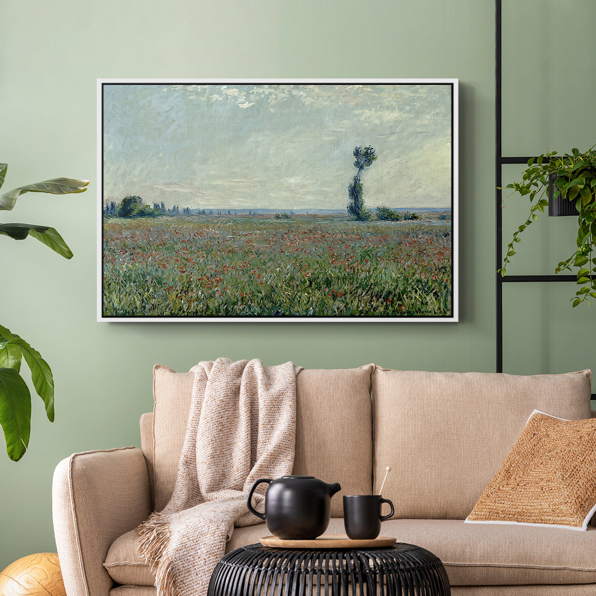 White floater framed canvas featuring a natural field scene with vibrant red flowers, displayed above a sofa in a modern living room.