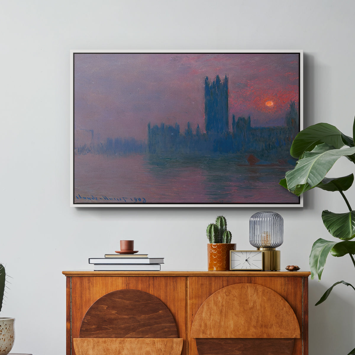 The Houses of Parliament, Sunset, 1903 by Claude Monet in a white floater framed canvas featuring a silhouette of Parliament buildings against glowing sunset across river, displayed above a wood console cabinet.